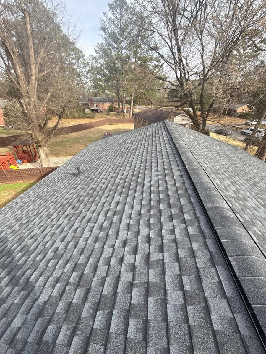 Gray shingle roof with a capped ridge vent above a fenced yard in Montevallo, AL